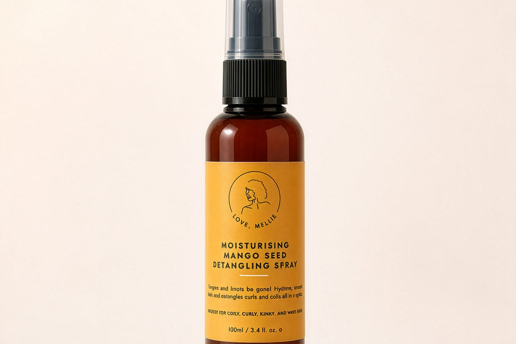 A 100ml amber glass spray bottle of 'The Beauty Brand' Moisturising Mango Seed Retinolmo Spray, featuring a mustard yellow label and black spray nozzle, set against a solid cream background.